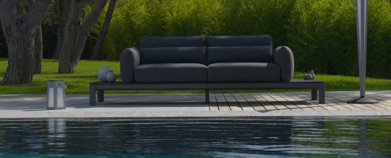 koton platform sofa in grey by a pool